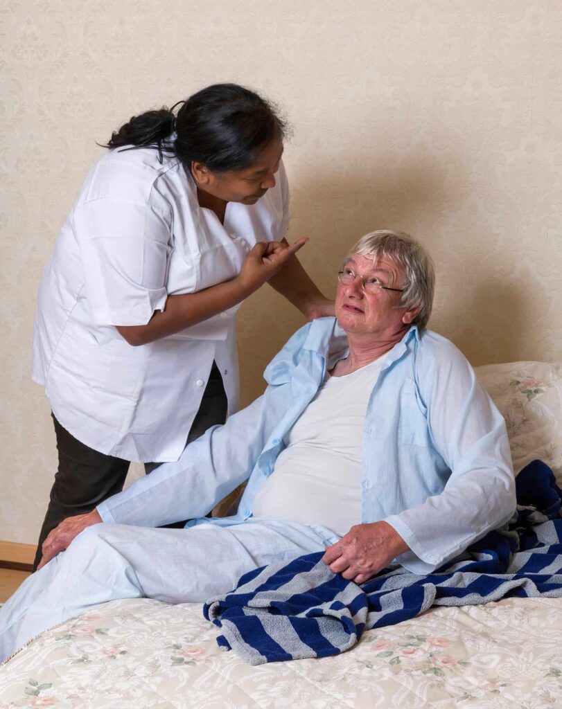 elderly person in bed being abused in nursing home