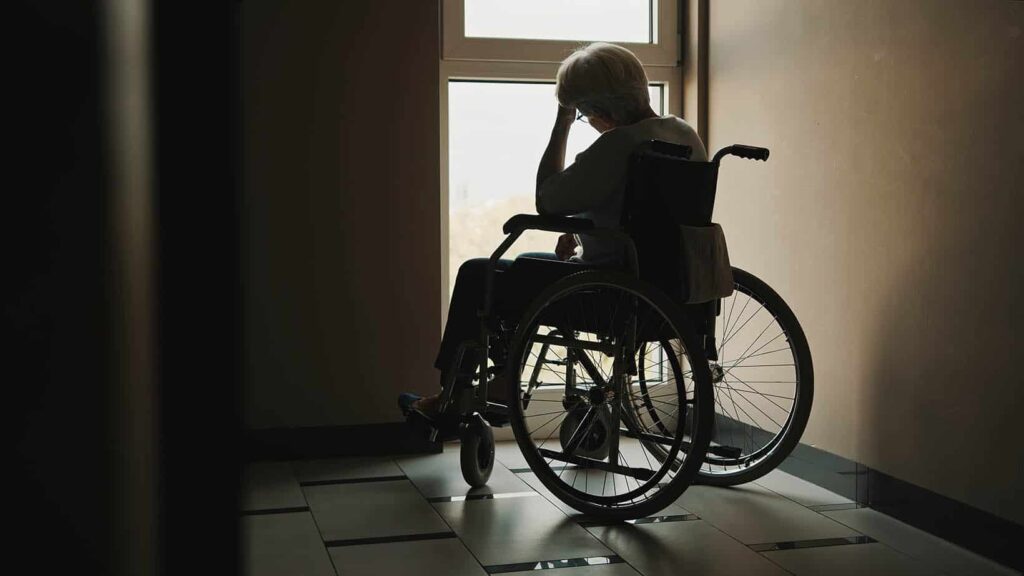 elderly person in wheelchair by window